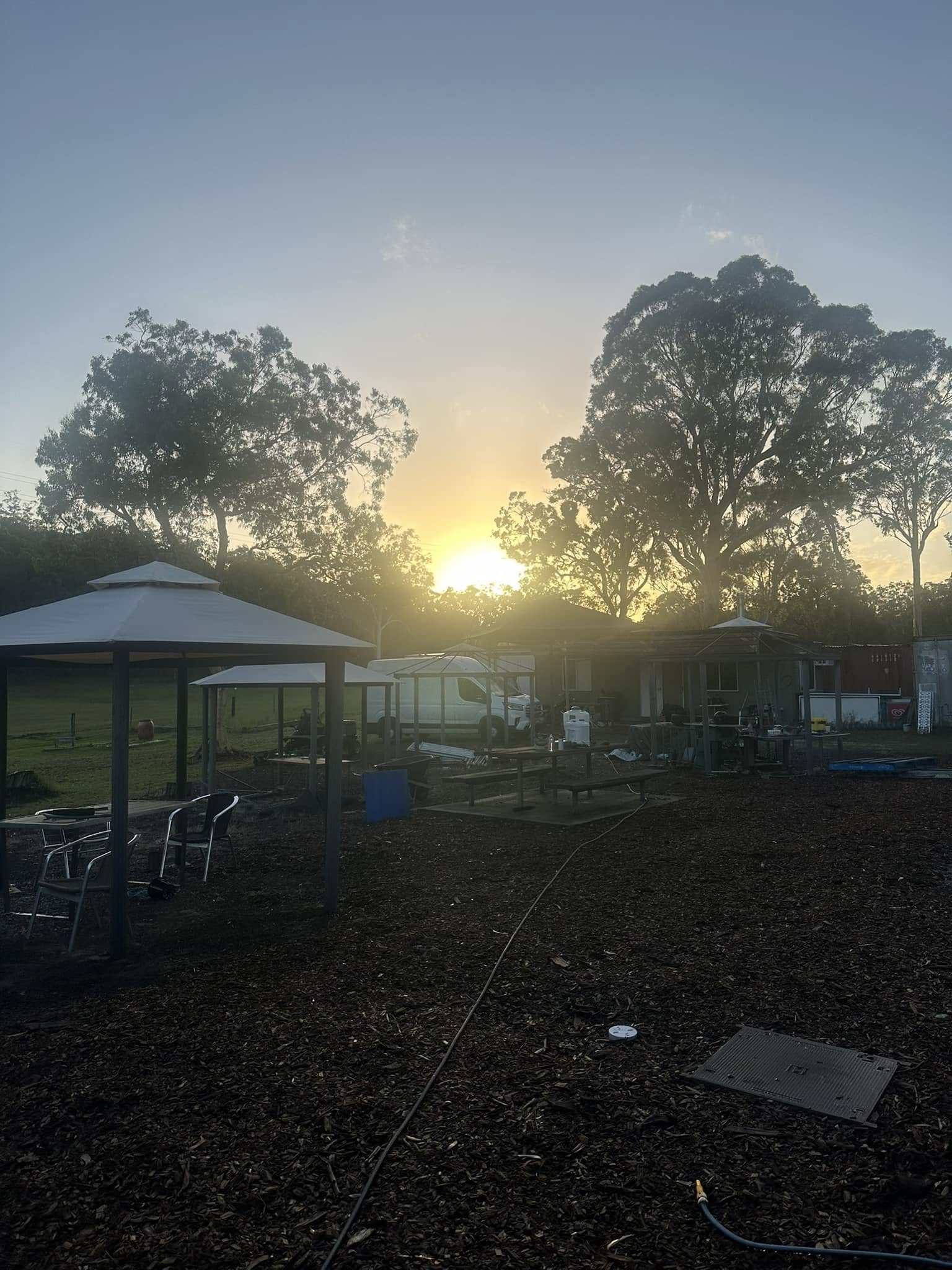 Dusk view of the gum trees and outdoor gazebos at Grey Gum Cafe on Putty Road